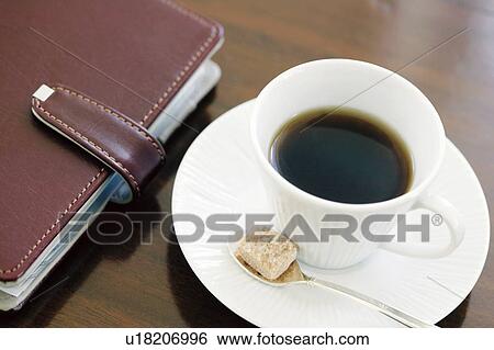 Personal organizer and cup of coffee View Large Photo Image Stock Photograph - Personal organizer and cup of coffee. Fotosearch