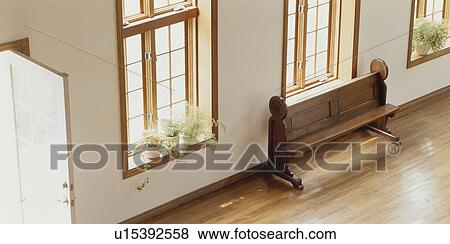 Stock Photo - Pew beside window in spacious room. Fotosearch