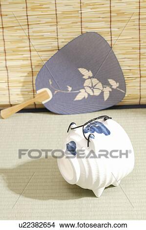 Pig-shaped incense burner and Japanese fan on Tatami mat View Large Photo Image Picture - Pig-shaped incense burner and Japanese fan on Tatami mat. Fotosearch