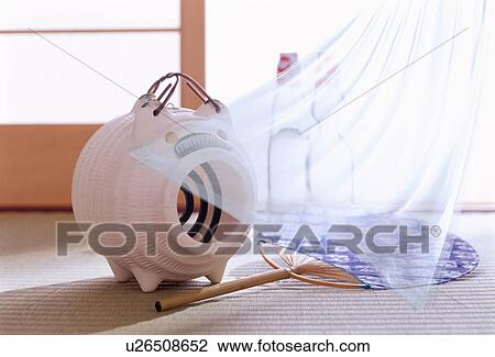 Stock Image - Pig-shaped mosquito coil and fan. Fotosearch