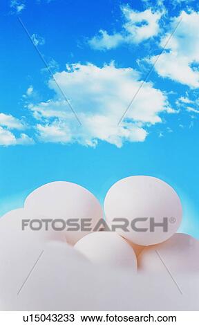 Stock Image - Pile of eggs under a blue sky. Fotosearch