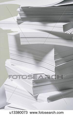 Stock Image - Piled papers, close up. Fotosearch