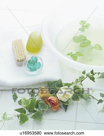 Stock Image - Plants and toiletries on towel. Fotosearch