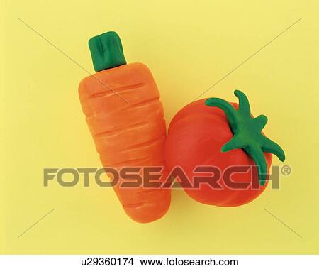Picture - Plasticine carrot and tomato. Fotosearch
