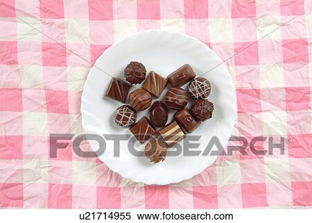 Plate of chocolates on pink tablecloth View Large Photo Image Stock Photography - Plate of chocolates on pink tablecloth. Fotosearch