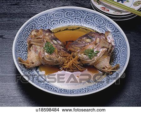 Picture - Plate of cooked sea bream heads. Fotosearch