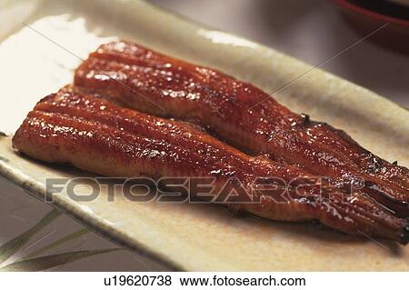 Stock Photo - Plate of grilled eel, close up. Fotosearch