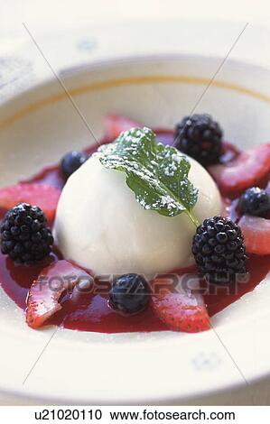Stock Image - Plate of lemon sorbet with berry sauce. Fotosearch