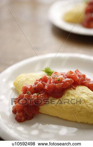 Stock Photo - Plate of omelet with tomato sauce. Fotosearch