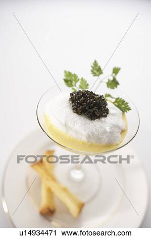 Stock Image - Poached egg with caviar, salmon and cream fraiche. Fotosearch