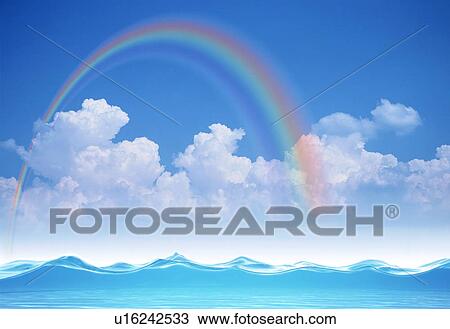 Stock Image - Rainbow over sea with clouds. Fotosearch
