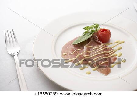 Stock Photo - Raw ham carpaccio with sauce. Fotosearch