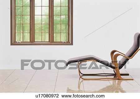 Stock Image - Reclining chair near window. Fotosearch