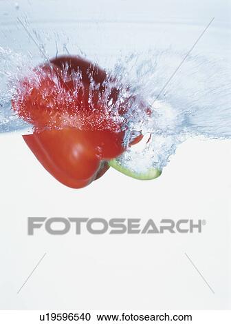 Red bell pepper falling into water View Large Photo Image Stock Image - Red bell pepper falling into water. Fotosearch