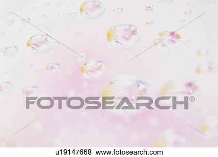Stock Photo - Reflections of pink flowers in droplets. Fotosearch