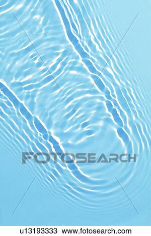 Stock Image - Rippled water with blue background. Fotosearch