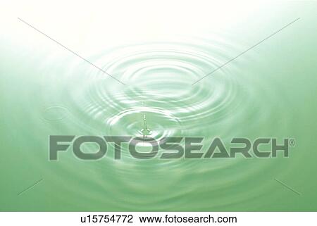 Stock Image - Rippled water with green background. Fotosearch