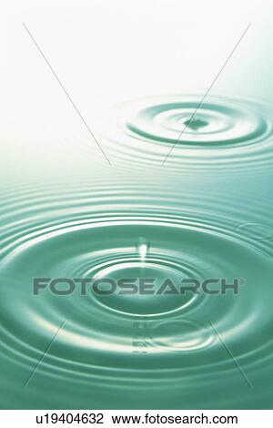 Stock Image - Rippled water with green background. Fotosearch