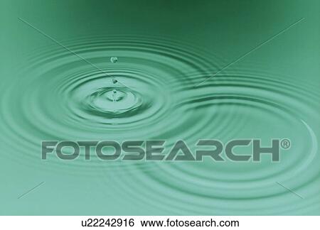 Stock Photograph - Rippled water with green background. Fotosearch