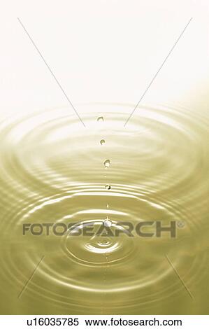 Stock Photography - Rippled water with yellow background. Fotosearch
