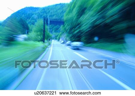 Stock Image - Road and traffic in blurred motion. Matsumoto, Nagano Prefecture, Japan. Fotosearch