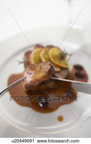 Stock Image - Roast duck with orange sauce. Fotosearch
