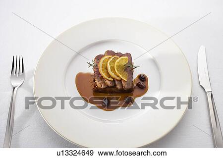 Stock Photo - Roast duck with orange sauce. Fotosearch