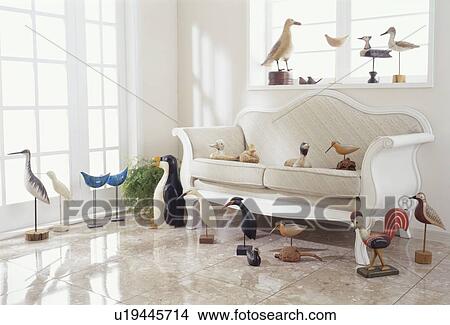 Picture - Room with sofa and various wooden birds. Fotosearch