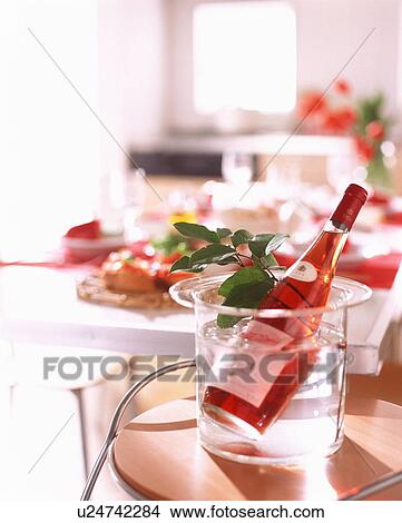 Rose wine bottle in water with plant leaf View Large Photo Image Picture - Rose wine bottle in water with plant leaf. Fotosearch