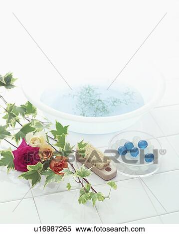 Stock Photography - Roses and toiletries on tile. Fotosearch