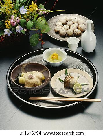 Picture - Sake and Japanese dishes, black background. Fotosearch