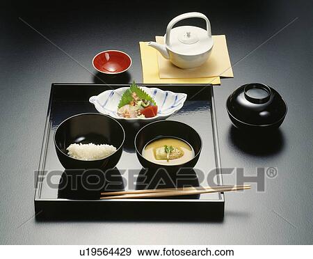 Stock Photo - Sake and Japanese dishes, black background. Fotosearch