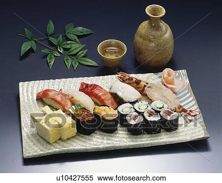 Stock Photography - Sake and Sushi on plate, black background. Fotosearch