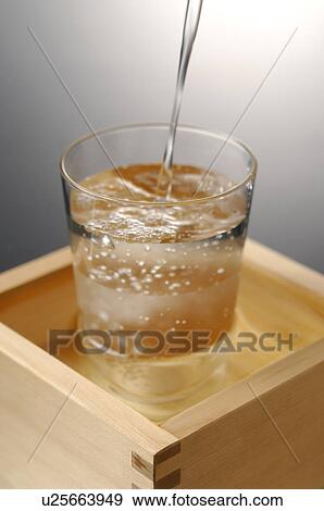 Sake pouring into glass, colored background View Large Photo Image Stock Photo - Sake pouring into glass, colored background. Fotosearch