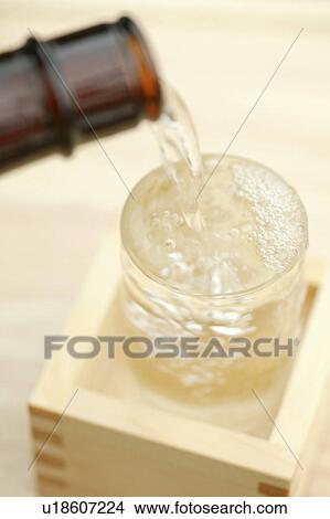 Picture - Sake pouring into glass. Fotosearch