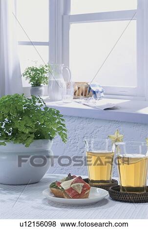 Sandwich and two glasses of juice on a table with a pot plant View Large Photo Image Stock Photo - Sandwich and two glasses of juice on a table with a pot plant. Fotosearch