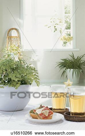 Sandwich and two glasses of juice on a table with a pot plant View Large Photo Image Stock Photograph - Sandwich and two glasses of juice on a table with a pot plant. Fotosearch