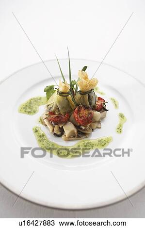 Stock Image - Sauteed escargot with mushrooms. Fotosearch