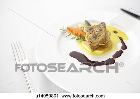 Stock Image - Sauteed meat with foie gras. Fotosearch