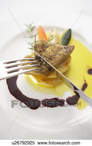 Stock Photography - Sauteed meat with foie gras. Fotosearch