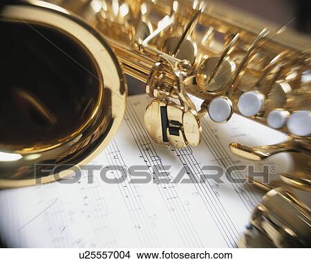 Saxophone and music sheet View Large Photo Image Picture - Saxophone and music sheet. Fotosearch
