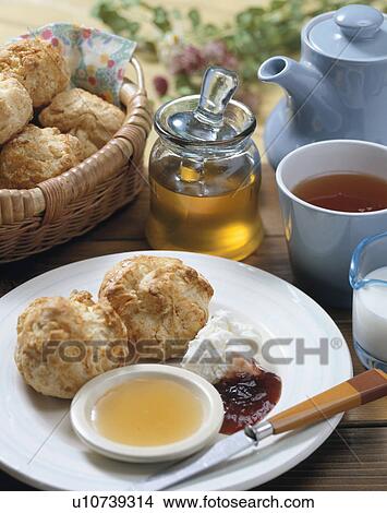 Picture - Scone with honey. Fotosearch