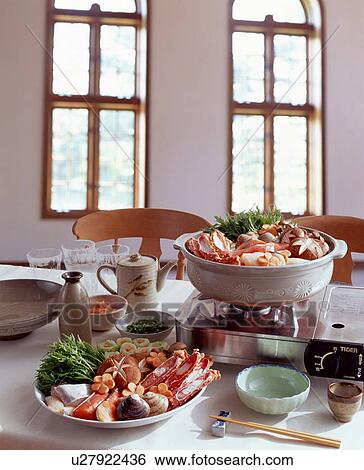 Stock Photograph - Seafood cooking in table top burner. Fotosearch