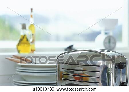 Stock Photo - Shiny metal toaster on kitchen counter. Fotosearch