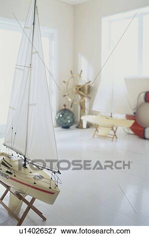 Stock Photo - Ship model and nautical equipment in room. Fotosearch