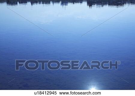 Silhouette of office buildings reflected on water surface, copy space View Large Photo Image Stock Photography - Silhouette of office buildings reflected on water surface, copy space. Fotosearch