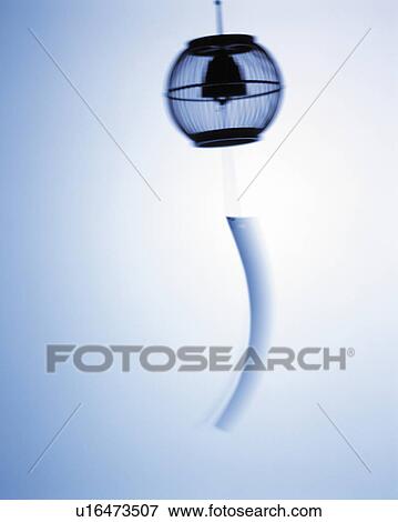 Stock Photo - Silhouette of wind chime, white background, blurred motion. Fotosearch