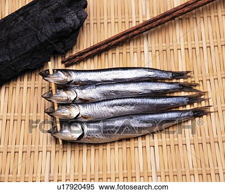 Stock Photography - Skewered fish on colander. Fotosearch