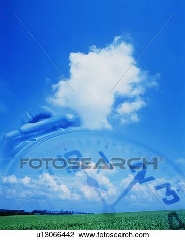 Stock Image - Sky with faded clock - digital composite. Fotosearch