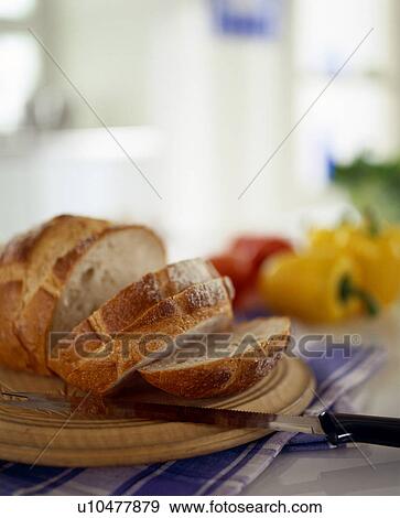 Stock Photo - Sliced bread on table with knife. Fotosearch